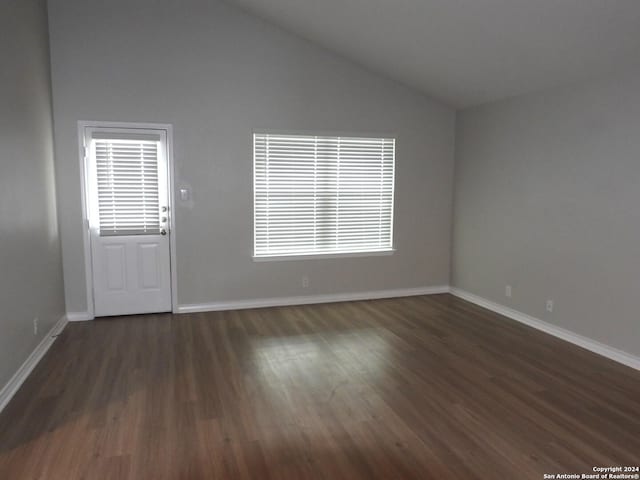 unfurnished room with dark hardwood / wood-style flooring and high vaulted ceiling