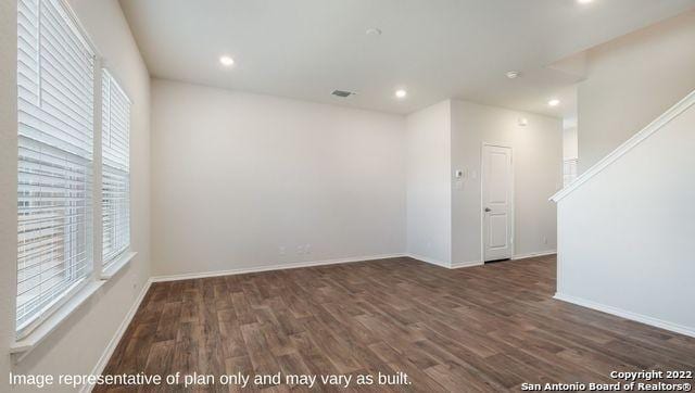 spare room featuring dark wood-type flooring