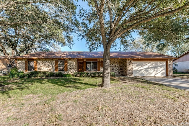 ranch-style home with a front lawn and a garage