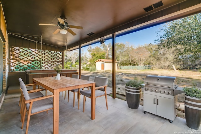 sunroom featuring ceiling fan