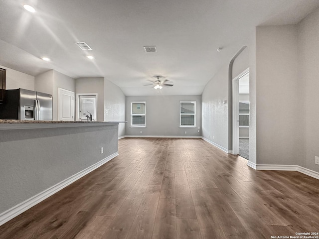 unfurnished living room featuring dark hardwood / wood-style floors, ceiling fan, and sink