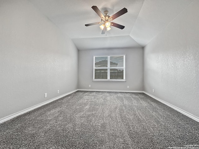 carpeted empty room with ceiling fan and vaulted ceiling