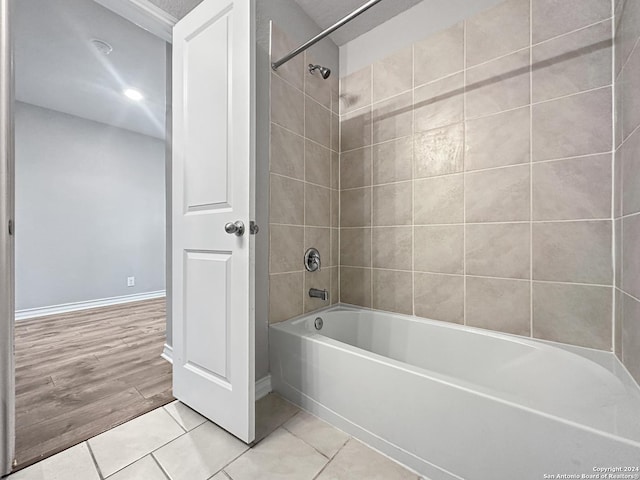 bathroom with tiled shower / bath and hardwood / wood-style flooring