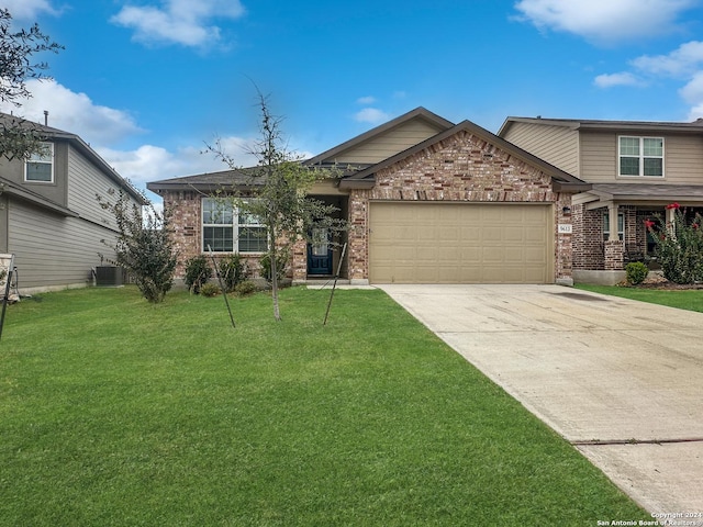 craftsman-style home with cooling unit, a front lawn, and a garage