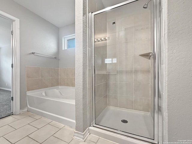 bathroom with tile patterned flooring and independent shower and bath