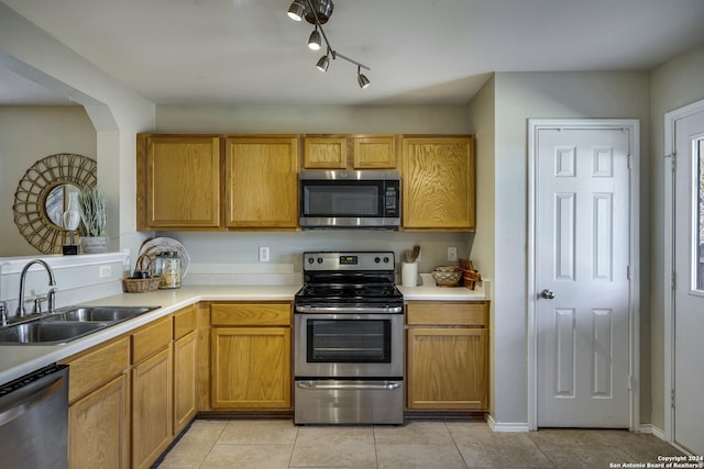 kitchen with light tile patterned floors, sink, and appliances with stainless steel finishes