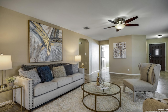 living room with ceiling fan and tile patterned flooring