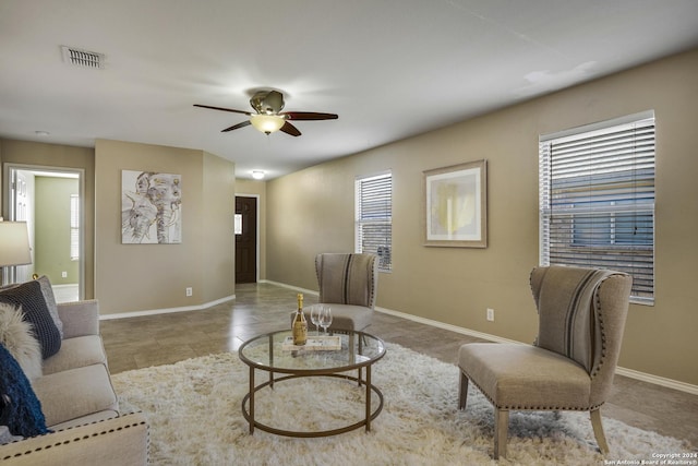 tiled living room featuring ceiling fan