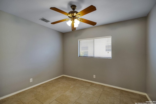 unfurnished room with ceiling fan and light tile patterned floors