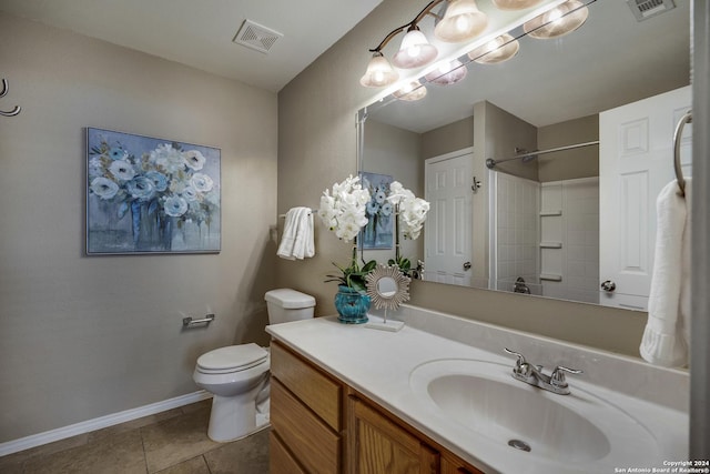 bathroom with toilet, vanity, tile patterned floors, and walk in shower