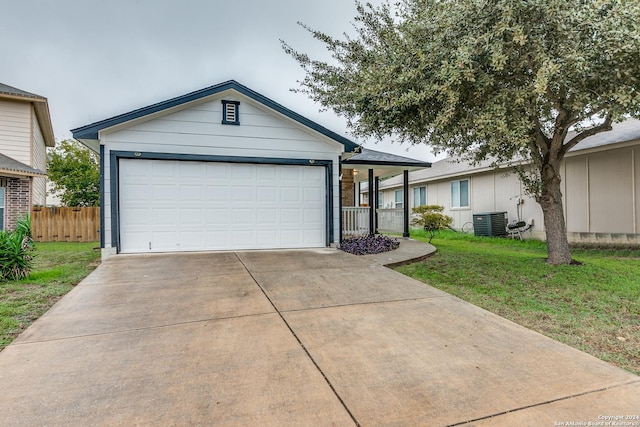 ranch-style home featuring central AC unit, a garage, and a front lawn