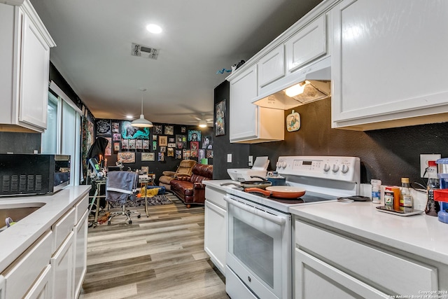 kitchen featuring pendant lighting, white range with electric stovetop, light wood-type flooring, and white cabinetry