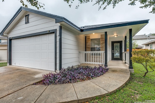 single story home featuring a porch and a garage