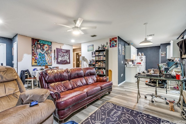 living room with ceiling fan and light wood-type flooring