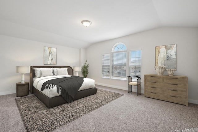 bedroom featuring vaulted ceiling and carpet flooring