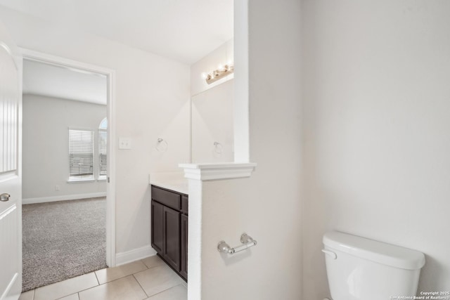 bathroom featuring vanity, toilet, and tile patterned flooring