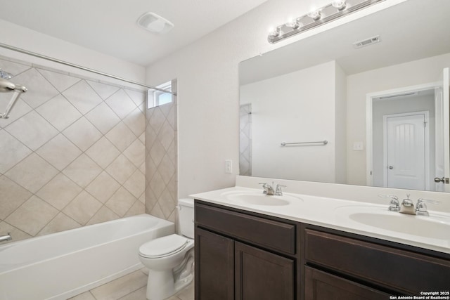 full bathroom featuring tiled shower / bath, vanity, toilet, and tile patterned flooring