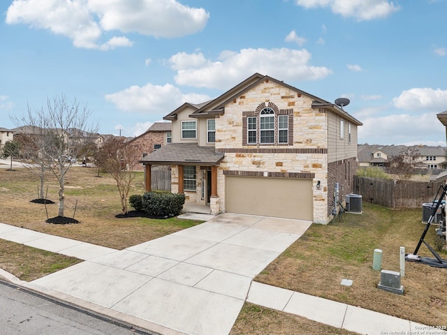 view of front of home with a garage, central air condition unit, and a front lawn