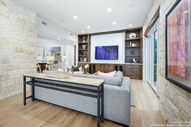 living room featuring light hardwood / wood-style flooring and built in features