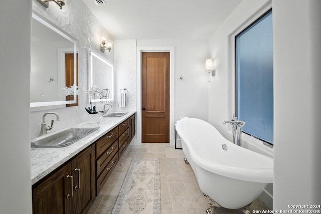 bathroom with a tub to relax in and vanity