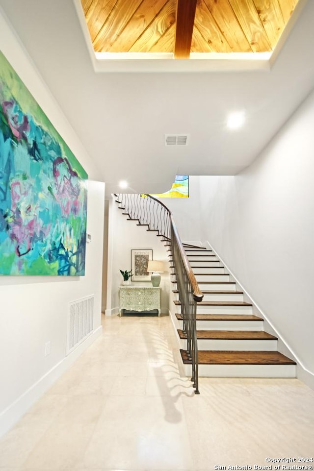 stairs featuring wooden ceiling