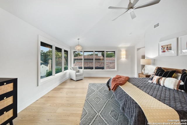 bedroom featuring ceiling fan, light wood-type flooring, and lofted ceiling