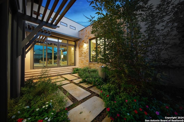 yard at dusk with a patio area and a pergola