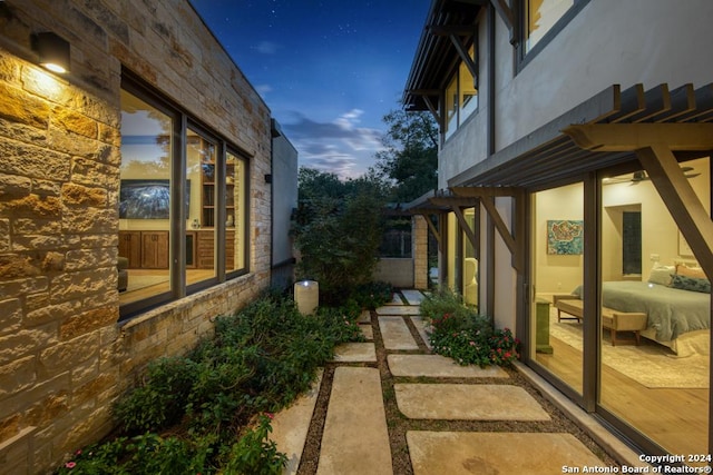 property exterior at dusk with a patio