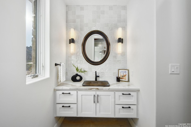 bathroom featuring decorative backsplash and vanity