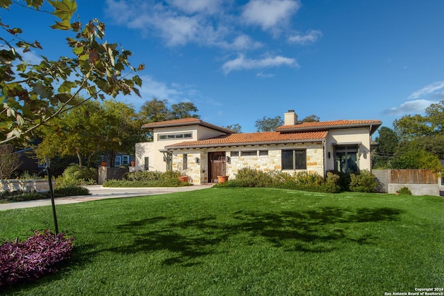 mediterranean / spanish-style house featuring a front lawn