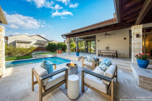 view of pool with ceiling fan, a patio, and an outdoor living space