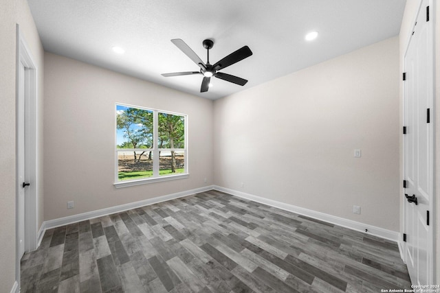 empty room featuring ceiling fan and dark wood-type flooring