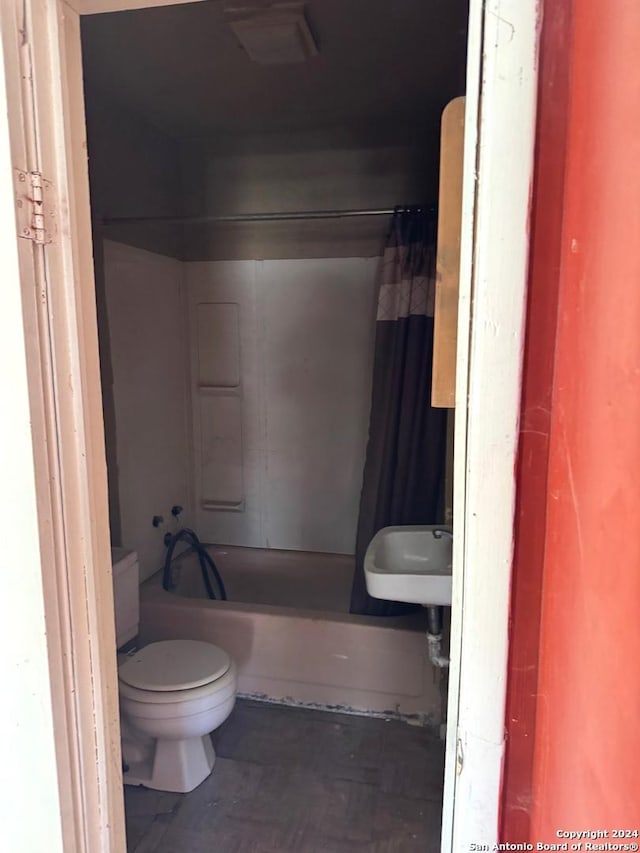 bathroom with shower / tub combo and toilet