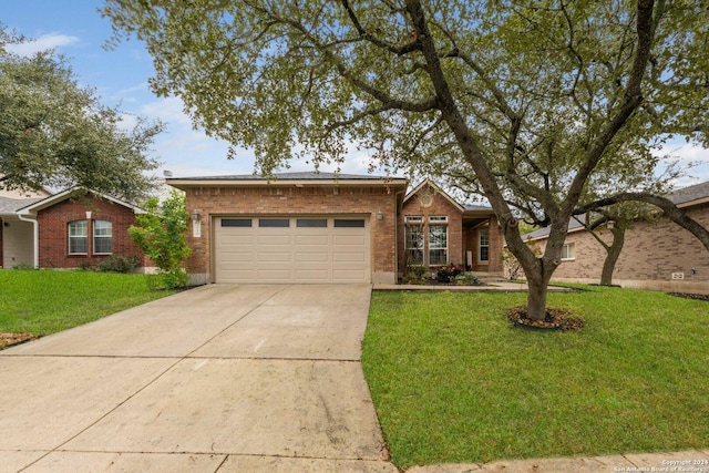 ranch-style home with a front yard and a garage