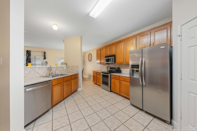 kitchen with backsplash, sink, light tile patterned flooring, and appliances with stainless steel finishes