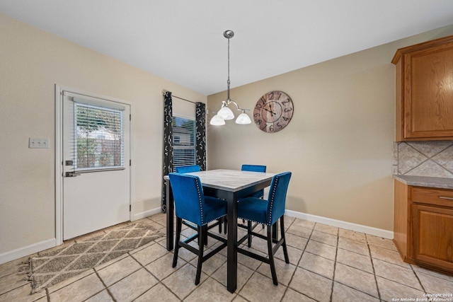 dining area featuring light tile patterned floors and a chandelier