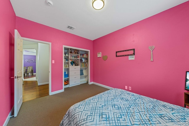 bedroom featuring dark carpet and a closet