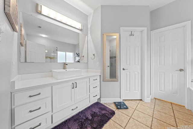 bathroom featuring a shower, vanity, and tile patterned floors