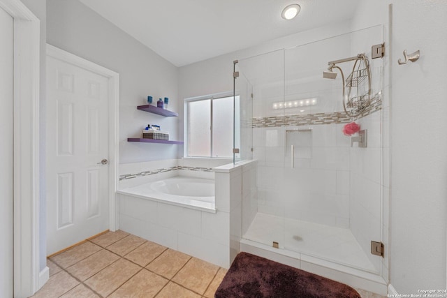 bathroom with shower with separate bathtub and tile patterned floors