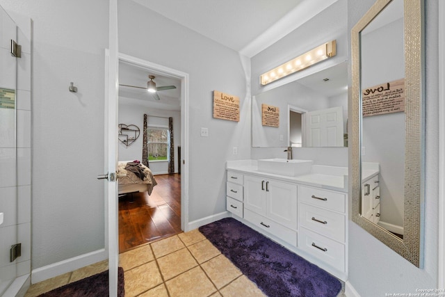 bathroom with hardwood / wood-style flooring, ceiling fan, and vanity