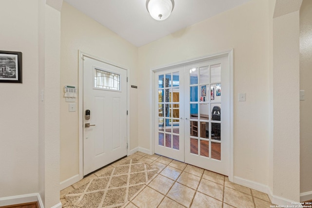 foyer with light tile patterned floors and french doors