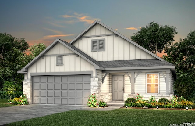 view of front facade with a garage and a lawn