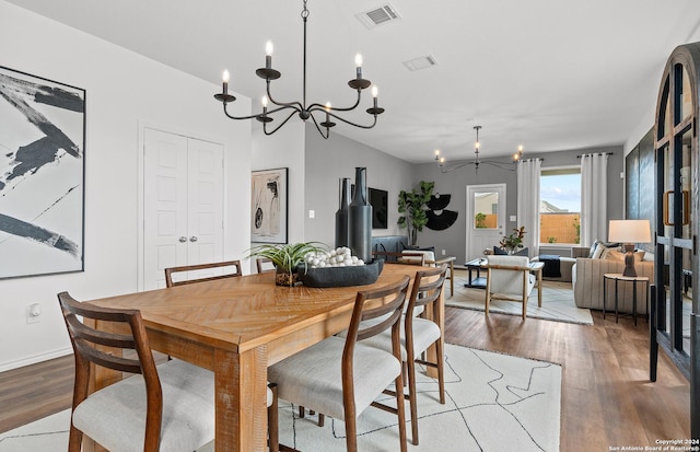 dining room with a chandelier and hardwood / wood-style flooring