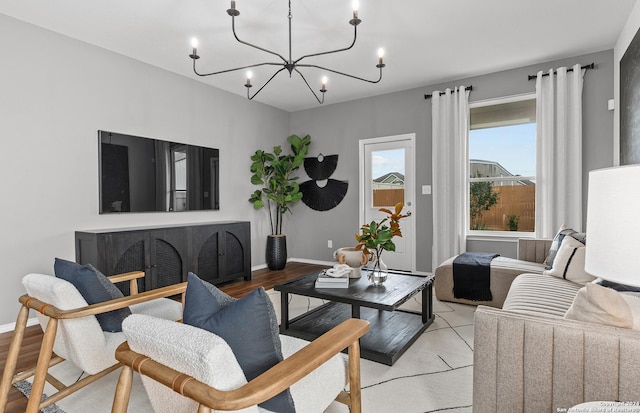 living room with an inviting chandelier and light hardwood / wood-style flooring