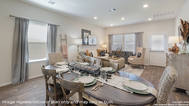 dining space with plenty of natural light and hardwood / wood-style floors