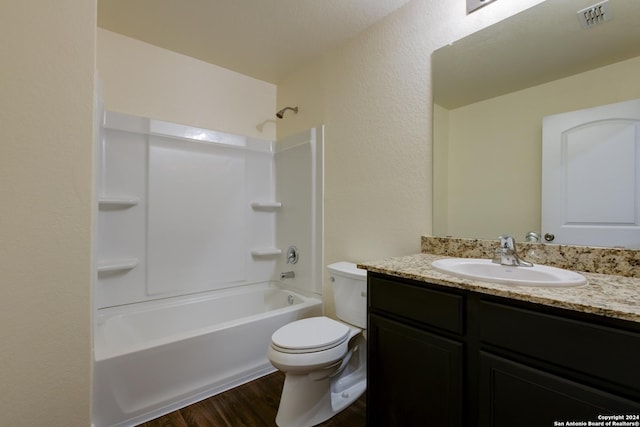 full bathroom with hardwood / wood-style flooring, vanity, toilet, and shower / washtub combination