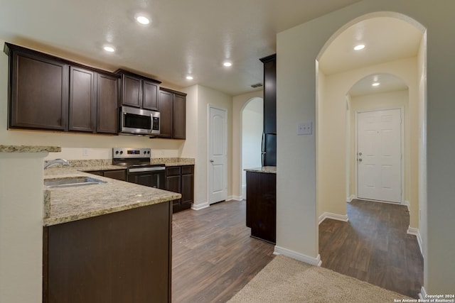 kitchen featuring dark hardwood / wood-style floors, sink, dark brown cabinetry, and stainless steel appliances