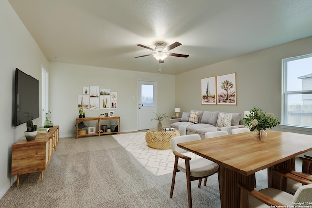 carpeted living room with ceiling fan