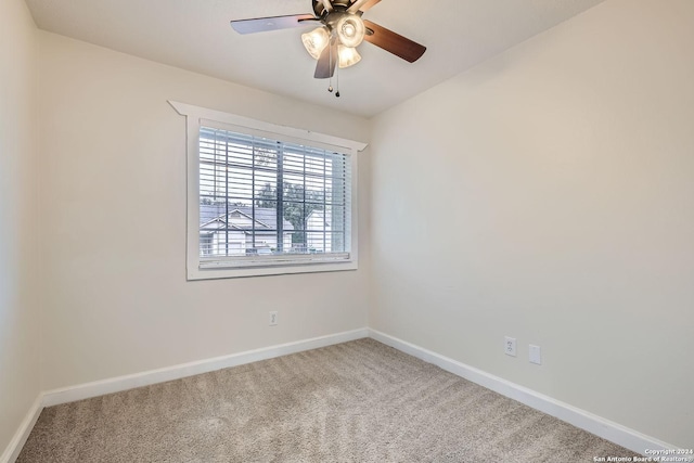 empty room featuring ceiling fan and carpet