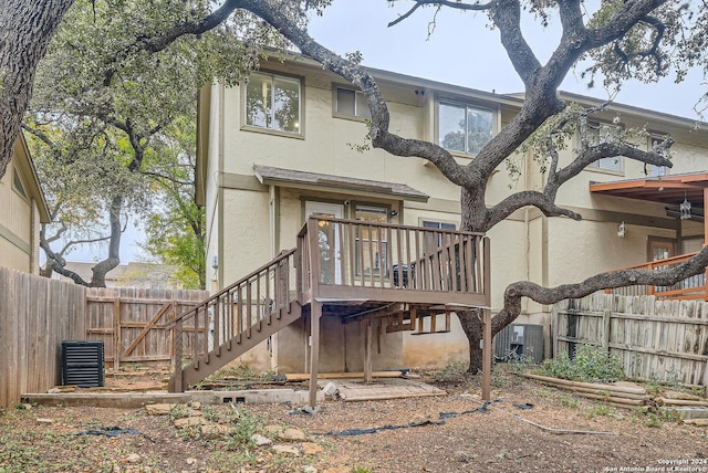 back of house featuring a deck and central air condition unit